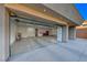 The expansive garage features a large roll-up door, epoxy flooring, and plenty of space for vehicles and storage at 677 Overlook Rim Dr, Henderson, NV 89012