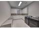 This spacious laundry room features modern appliances, ample counter space, and a stylish design at 677 Overlook Rim Dr, Henderson, NV 89012