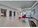 Bright, open-concept living space with modern decor, tile floors, and access to outdoor views at 677 Overlook Rim Dr, Henderson, NV 89012