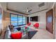 Comfortable living room with plush seating, modern ceiling fan, and expansive windows offering stunning outdoor views at 677 Overlook Rim Dr, Henderson, NV 89012