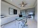 A bright office space featuring glass desk, sleek cabinetry, modern chair and elegant decor at 677 Overlook Rim Dr, Henderson, NV 89012