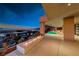 Enjoy the outdoor living space with a fire feature, pool and stunning city views at sunset at 677 Overlook Rim Dr, Henderson, NV 89012