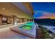 Enjoy the evening swimming in the pool with built-in spa and city views at 677 Overlook Rim Dr, Henderson, NV 89012