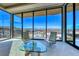Sitting area with stylish chairs and table boasting floor-to-ceiling windows and panoramic views at 677 Overlook Rim Dr, Henderson, NV 89012