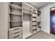 Spacious walk-in closet with custom shelving, drawers, and ample storage space for organization at 677 Overlook Rim Dr, Henderson, NV 89012