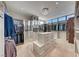 Well-organized walk-in closet with custom shelving, drawers, and ample storage space with chandelier at 677 Overlook Rim Dr, Henderson, NV 89012