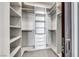 Well-organized walk-in closet with custom shelving, drawers, and hanging rods for efficient storage solutions at 677 Overlook Rim Dr, Henderson, NV 89012