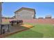 Spacious backyard featuring a wood deck and a grill, perfect for outdoor entertaining at 7828 Bright Lodge St, Las Vegas, NV 89139