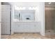 Bathroom features a double vanity, marble countertops, tile flooring and a glass-enclosed shower at 7828 Bright Lodge St, Las Vegas, NV 89139