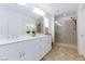 Bathroom featuring a double vanity, marble countertops, tile flooring and a glass-enclosed shower at 7828 Bright Lodge St, Las Vegas, NV 89139