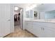 Bathroom showcasing double vanity, marble countertops, and a walk-in closet at 7828 Bright Lodge St, Las Vegas, NV 89139