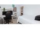 Bedroom with a white bed, a desk, and a chair for working or studying at 7828 Bright Lodge St, Las Vegas, NV 89139