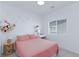 Cozy bedroom with a pink bed, a nightstand, and a window that lets in natural light at 7828 Bright Lodge St, Las Vegas, NV 89139