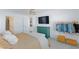 Bright bedroom featuring a TV, a teal dresser, and carpet flooring at 7828 Bright Lodge St, Las Vegas, NV 89139