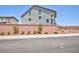 Two-story home exterior with landscaped front yard, behind a brick wall at 7828 Bright Lodge St, Las Vegas, NV 89139