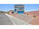 Inviting two-story home with a blue garage door, solar panels, and a stone driveway at 7828 Bright Lodge St, Las Vegas, NV 89139