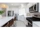 Bright, modern kitchen with stainless steel appliances, an island with seating, and white cabinetry at 7828 Bright Lodge St, Las Vegas, NV 89139