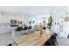 Bright living room with white cabinets, kitchen island, wooden table, and modern decor accents at 7828 Bright Lodge St, Las Vegas, NV 89139