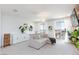 Bright living room featuring a comfortable sectional sofa, stylish decor, and large windows for ample natural light at 7828 Bright Lodge St, Las Vegas, NV 89139