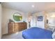 Spacious bedroom with a dresser, a round decorative mirror, and an en suite bathroom at 7935 Pandora Sky St # 381, North Las Vegas, NV 89084