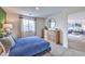Comfortable bedroom with plush carpet, stylish dresser, and abundant natural light from a well-placed window at 7935 Pandora Sky St # 381, North Las Vegas, NV 89084