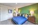 Bright bedroom featuring a modern accent wall, plush carpet, and stylish nightstands and lamps at 7935 Pandora Sky St # 381, North Las Vegas, NV 89084