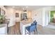 Well-lit kitchen with stainless appliances, gray counters, and seamless wood-look flooring at 7935 Pandora Sky St # 381, North Las Vegas, NV 89084