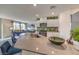 Bright kitchen featuring granite counters, stainless steel appliances, and an open layout to the living room at 7935 Pandora Sky St # 381, North Las Vegas, NV 89084
