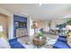 Bright living room with blue sofa, wood dining table and an open floor plan at 7935 Pandora Sky St # 381, North Las Vegas, NV 89084