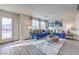 Living room with a blue sofa and a round coffee table at 7935 Pandora Sky St # 381, North Las Vegas, NV 89084