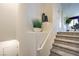 Staircase with neutral carpeting, white walls, and decorative plants on a ledge at 7935 Pandora Sky St # 381, North Las Vegas, NV 89084