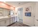 A primary bathroom with double sinks, wood floors and a large mirror at 795 Calm Crystal Ct # Lot 141, North Las Vegas, NV 89081