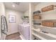 Well-organized laundry room with shelving, baskets, and a modern washer and dryer at 795 Calm Crystal Ct # Lot 141, North Las Vegas, NV 89081