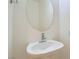 A pedestal sink with an oval mirror provides a simple solution to save space in a small bathroom at 8040 Arcadian Ln, Las Vegas, NV 89147