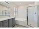 Modern bathroom featuring double sinks, a soaking tub, walk in shower and stylish tile at 8040 Arcadian Ln, Las Vegas, NV 89147