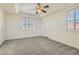 A spacious bedroom provides room to relax with its carpet, ceiling fan, and plantation shutters at 8040 Arcadian Ln, Las Vegas, NV 89147