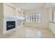 Spacious living room with tile flooring, a modern fireplace, and natural light at 8040 Arcadian Ln, Las Vegas, NV 89147