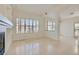 Open-concept living area with tile flooring, plantation shutters and a fireplace at 8040 Arcadian Ln, Las Vegas, NV 89147