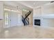 Bright living room featuring tile floors, a fireplace, and an elegant staircase at 8040 Arcadian Ln, Las Vegas, NV 89147