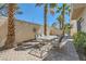 Charming patio with brick pavers, patio table and chairs, and lush trees, ideal for entertaining guests at 8040 Arcadian Ln, Las Vegas, NV 89147