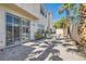 Enchanting outdoor patio with sliding glass doors, patio table and chairs, and vibrant greenery for outdoor relaxation at 8040 Arcadian Ln, Las Vegas, NV 89147