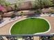 Aerial view of backyard featuring lush green grass, retaining wall, and private outdoor space at 8397 San Ramon Dr, Las Vegas, NV 89147