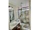 A modern bathroom features stone-look tile in the shower and a vessel sink at 8397 San Ramon Dr, Las Vegas, NV 89147