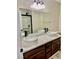 Modern bathroom featuring dual vessel sinks, dark wood cabinets, and a walk-in shower at 8397 San Ramon Dr, Las Vegas, NV 89147