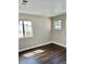 Cozy bedroom with wood floors and two windows, offering a comfortable and bright space at 8397 San Ramon Dr, Las Vegas, NV 89147