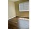 This bedroom features hardwood floors, base trim, neutral paint, and a window at 8397 San Ramon Dr, Las Vegas, NV 89147