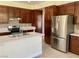 Kitchen with stainless steel appliances, tiled backsplash, and wooden cabinets at 8397 San Ramon Dr, Las Vegas, NV 89147