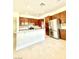 Kitchen with stainless steel appliances, wooden cabinetry and stone floors at 8397 San Ramon Dr, Las Vegas, NV 89147