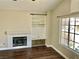 Comfortable living room with fireplace, built-in shelving, and a window for natural light at 8397 San Ramon Dr, Las Vegas, NV 89147