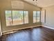 Spacious living room with wood floors and large windows, offering ample natural light and a view at 8397 San Ramon Dr, Las Vegas, NV 89147